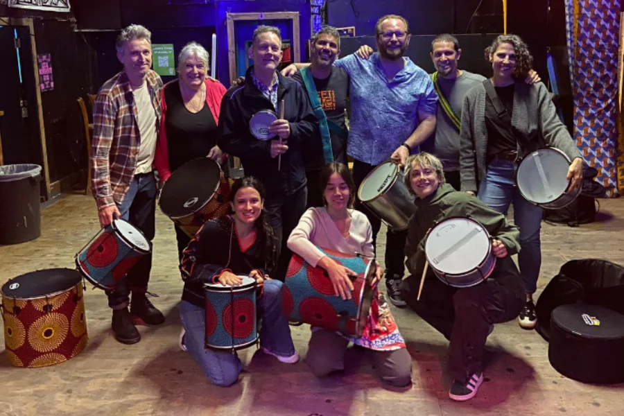 A group of samba workshop students with their percussion instruments