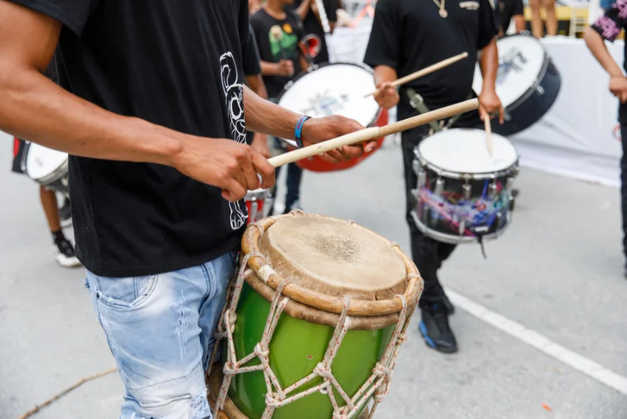 A man playing samba percussion in a street parade